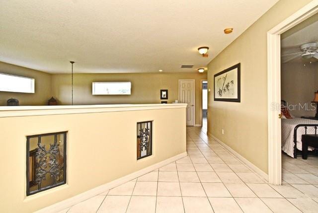 corridor featuring light tile patterned floors
