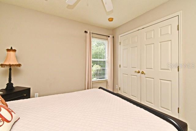 bedroom featuring a ceiling fan and a closet