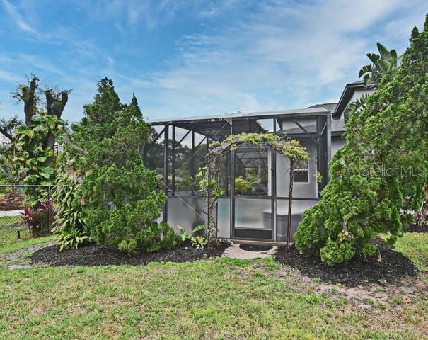 view of yard featuring glass enclosure
