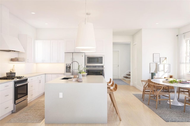 12536 Westhaven Oak Dr Unit 111, Winter Garden, FL 34787 - kitchen with appliances with stainless steel finishes, a sink, decorative backsplash, white cabinetry, and light countertops