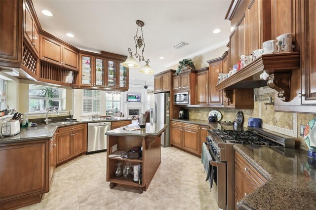 6686 SE 135th St, Summerfield, FL 34491 - kitchen featuring appliances with stainless steel finishes, a sink, tasteful backsplash, open shelves, and a center island