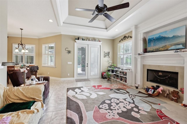6686 SE 135th St, Summerfield, FL 34491 - living area with a glass covered fireplace, a raised ceiling, crown molding, light tile patterned flooring, and ceiling fan