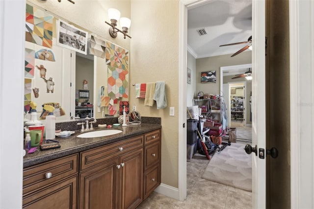 6686 SE 135th St, Summerfield, FL 34491 - bathroom featuring a ceiling fan, vanity, tile patterned flooring, and crown molding