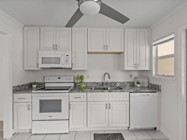 kitchen featuring white appliances, a sink, dark stone countertops, white cabinetry, and ornamental molding