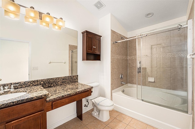 full bath with tile patterned floors, toilet, combined bath / shower with glass door, vanity, and baseboards