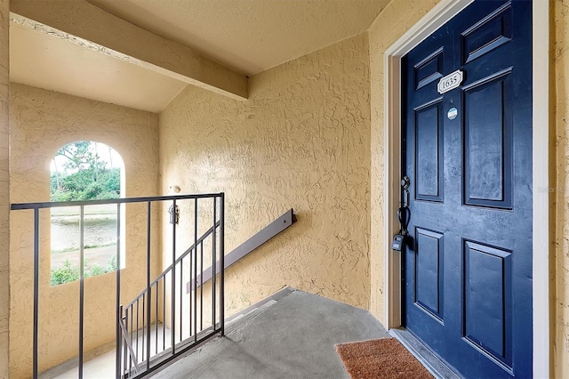 entrance to property with stucco siding