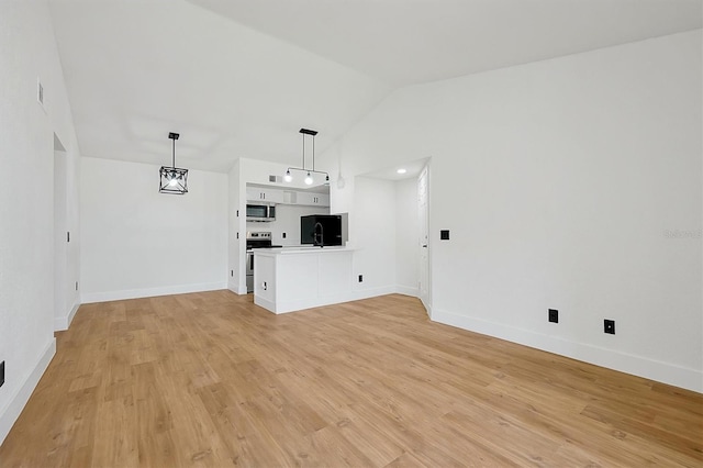 unfurnished living room with vaulted ceiling, light wood-style floors, and baseboards