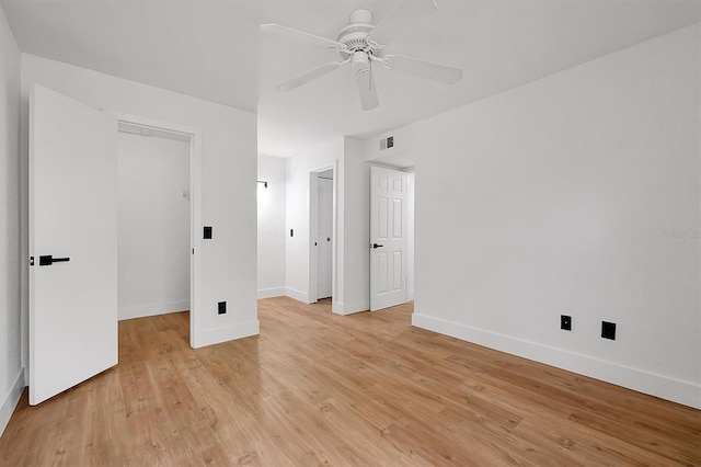 unfurnished bedroom featuring baseboards, light wood finished floors, and ceiling fan