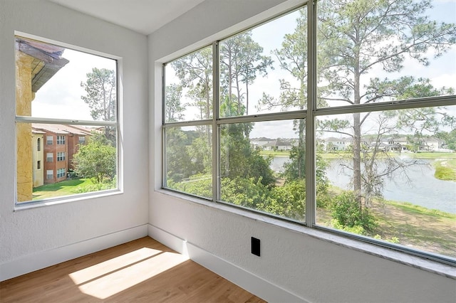 unfurnished sunroom with a water view