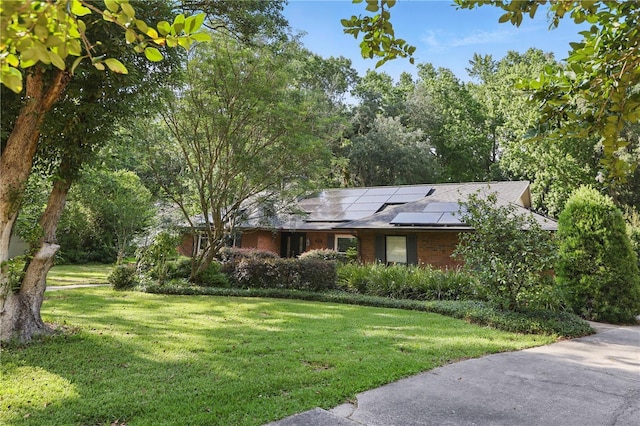 628 Riverpark Cir, Longwood, FL 32779 - single story home featuring a front lawn, brick siding, and solar panels