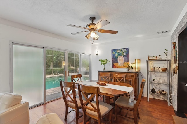 628 Riverpark Cir, Longwood, FL 32779 - dining room with wood finished floors, ceiling fan, and a textured ceiling