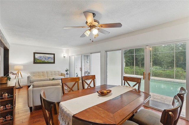 628 Riverpark Cir, Longwood, FL 32779 - dining space featuring wood finished floors, a ceiling fan, a textured ceiling, and baseboards