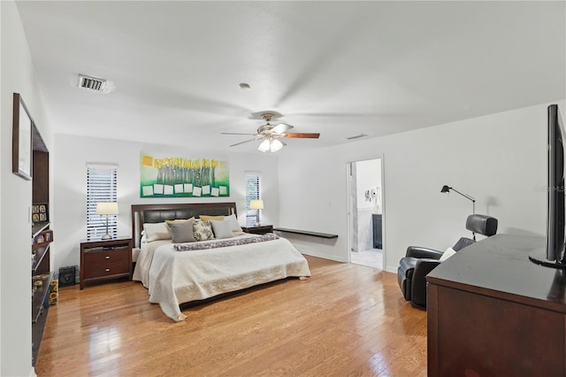 628 Riverpark Cir, Longwood, FL 32779 - bedroom with light wood-style floors, a ceiling fan, and connected bathroom