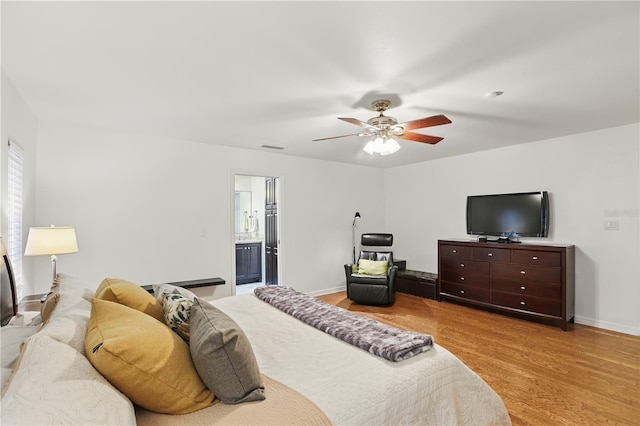 628 Riverpark Cir, Longwood, FL 32779 - bedroom featuring light wood finished floors, baseboards, ceiling fan, and connected bathroom