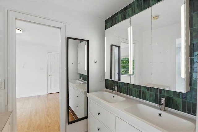 628 Riverpark Cir, Longwood, FL 32779 - bathroom with decorative backsplash, double vanity, and wood finished floors