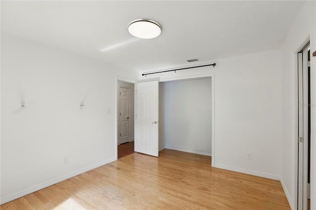 628 Riverpark Cir, Longwood, FL 32779 - unfurnished bedroom with light wood-type flooring, baseboards, and a closet