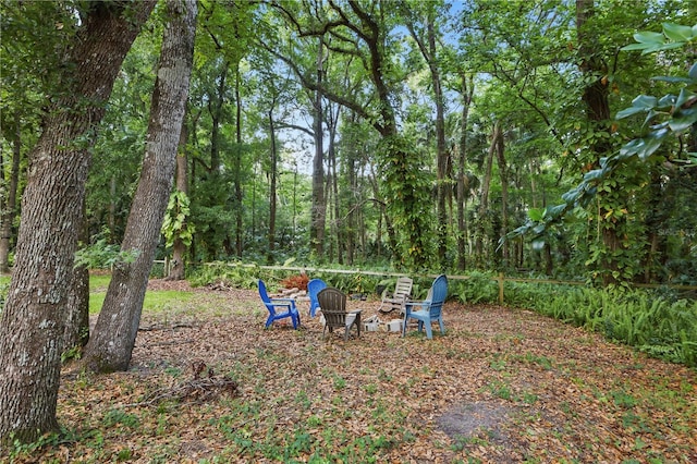 628 Riverpark Cir, Longwood, FL 32779 - view of yard featuring an outdoor fire pit and a view of trees