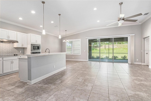 1602 W Caroline Path, Lecanto, FL 34461 - kitchen featuring stainless steel microwave, ornamental molding, under cabinet range hood, tasteful backsplash, and recessed lighting