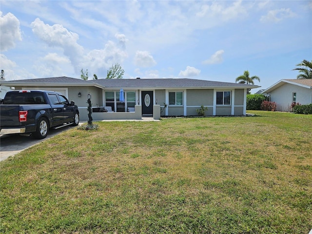 119 Caddy Rd, Rotonda West, FL 33947 - single story home with stucco siding, a garage, and a front yard