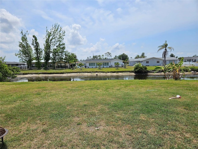 119 Caddy Rd, Rotonda West, FL 33947 - view of green lawn featuring a residential view and a water view