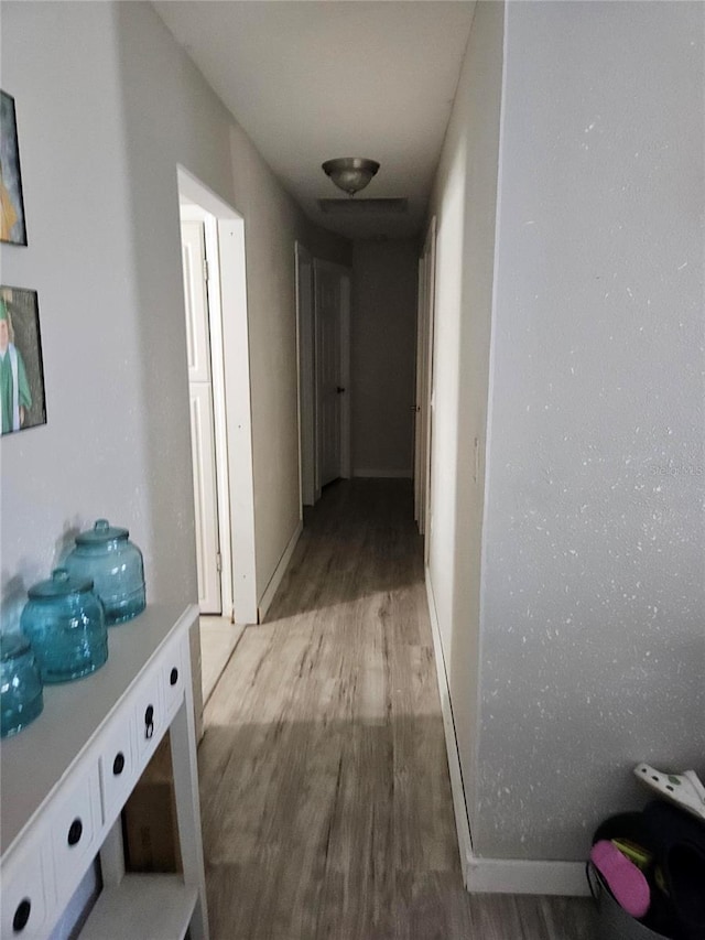 119 Caddy Rd, Rotonda West, FL 33947 - hallway with wood finished floors and baseboards