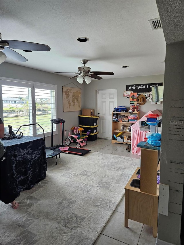 119 Caddy Rd, Rotonda West, FL 33947 - game room featuring ceiling fan, a textured ceiling, and tile patterned floors