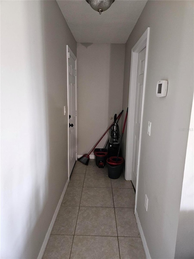 119 Caddy Rd, Rotonda West, FL 33947 - corridor with light tile patterned floors and baseboards