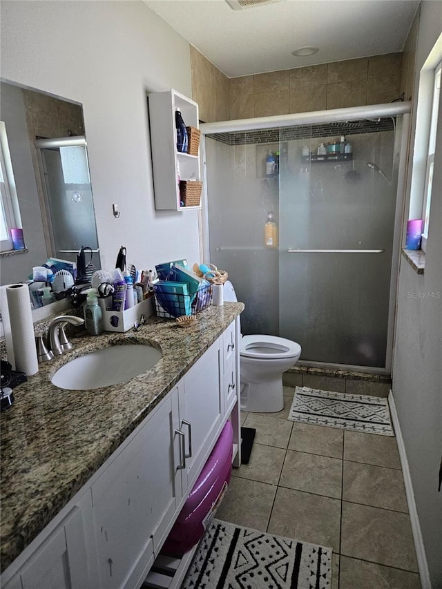 119 Caddy Rd, Rotonda West, FL 33947 - full bathroom with vanity, a stall shower, toilet, and tile patterned floors