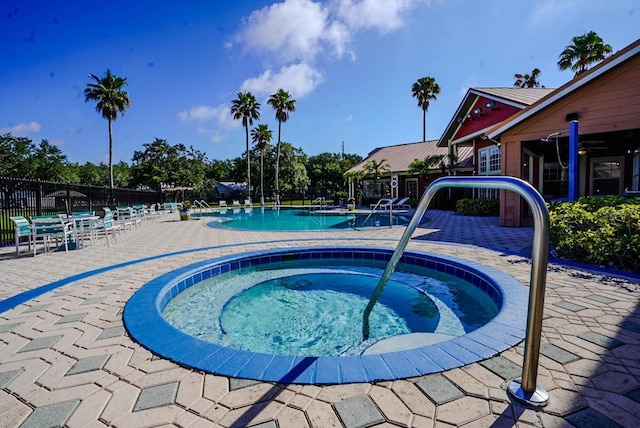 2208 Antigua Pl Unit 932, Kissimmee, FL 34741 - community pool with fence, a community hot tub, and a patio