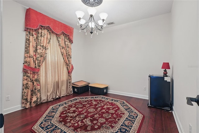 dining room featuring a chandelier, wood finished floors, and baseboards