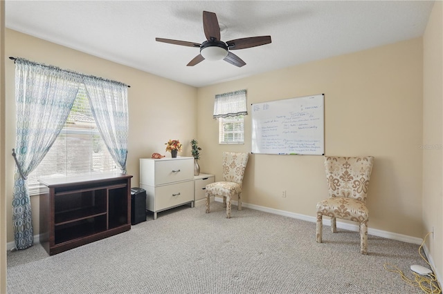 sitting room featuring carpet flooring, a ceiling fan, and baseboards