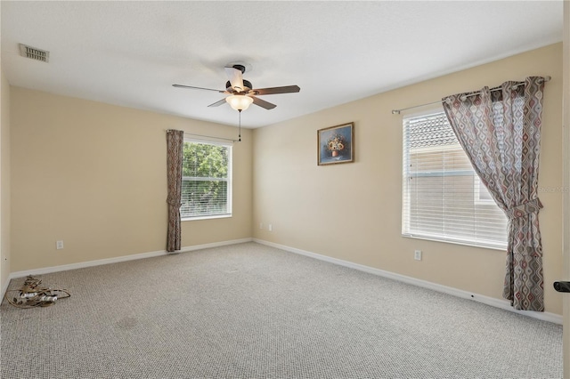 spare room featuring a ceiling fan, carpet flooring, and baseboards