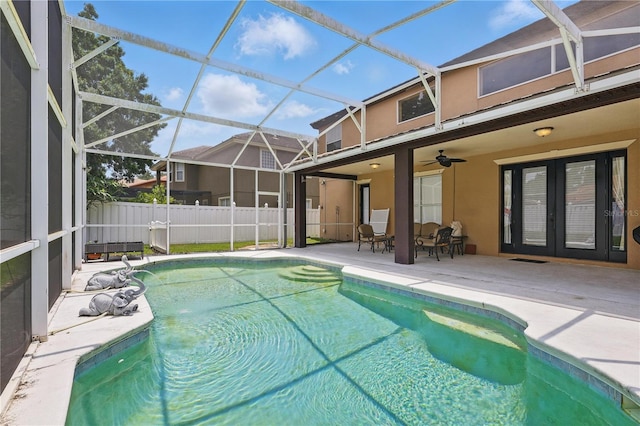 view of pool featuring french doors, a patio, fence, and glass enclosure