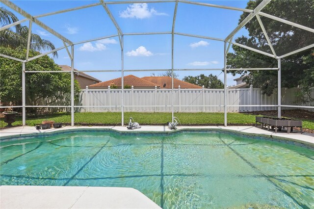 view of pool with a fenced backyard, a lanai, and a patio area