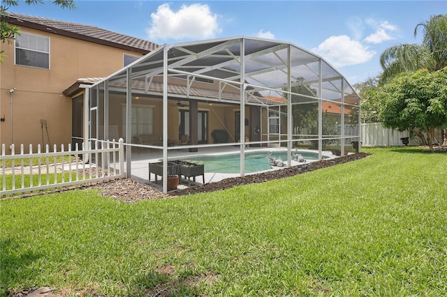 rear view of house featuring ceiling fan, a patio area, stucco siding, a lanai, and a tiled roof
