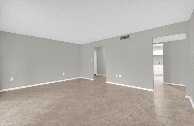 514 Orange Dr Unit 31, Altamonte Springs, FL 32701 - empty room featuring baseboards, light tile patterned flooring, and a sink