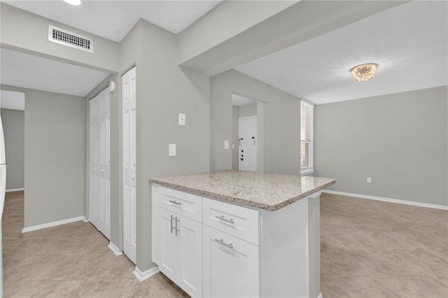 514 Orange Dr Unit 31, Altamonte Springs, FL 32701 - kitchen with white cabinetry, light stone counters, and baseboards
