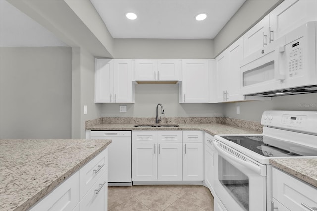 514 Orange Dr Unit 31, Altamonte Springs, FL 32701 - kitchen with white appliances, a sink, white cabinets, light tile patterned floors, and light stone countertops