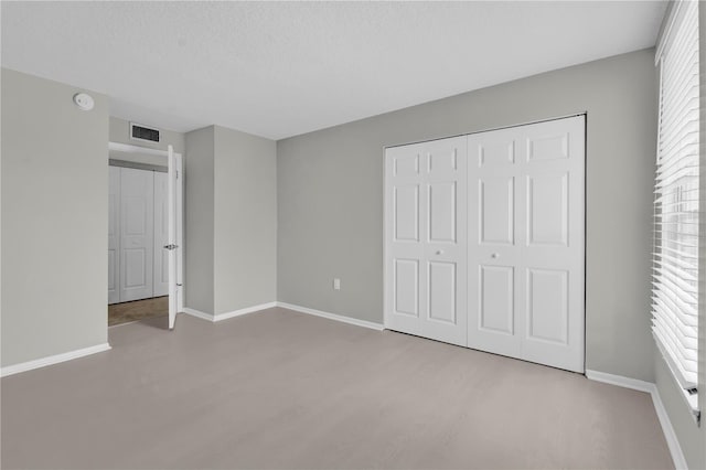 514 Orange Dr Unit 31, Altamonte Springs, FL 32701 - unfurnished bedroom featuring multiple windows, a closet, and baseboards