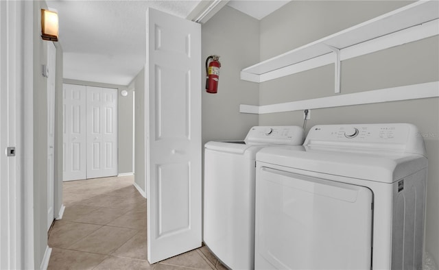 514 Orange Dr Unit 31, Altamonte Springs, FL 32701 - laundry room with separate washer and dryer, light tile patterned floors, and baseboards