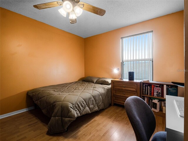 408 Becky St, Orlando, FL 32824 - bedroom featuring wood finished floors, a textured ceiling, and a ceiling fan