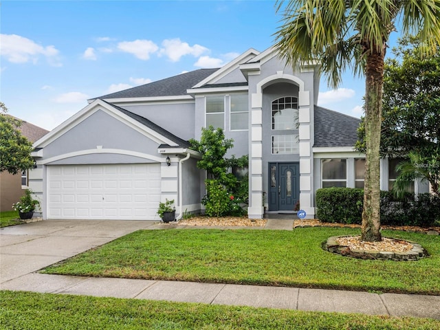 408 Becky St, Orlando, FL 32824 - view of front of home with stucco siding, a front yard, an attached garage, roof with shingles, and driveway