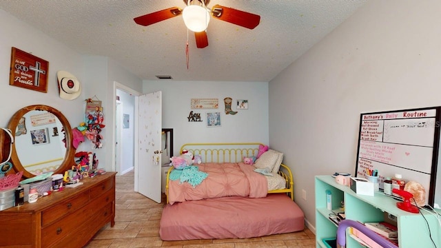 12381 Antonio Cir, Orlando, FL 32826 - bedroom featuring a textured ceiling, a ceiling fan, and light wood finished floors