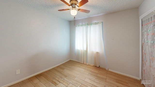 12381 Antonio Cir, Orlando, FL 32826 - unfurnished room featuring a ceiling fan, light wood finished floors, a textured ceiling, and baseboards