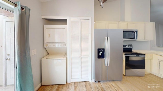 12381 Antonio Cir, Orlando, FL 32826 - laundry room with stacked washer / drying machine and light wood-type flooring