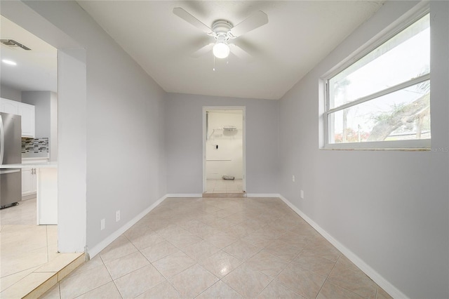 4824 Shoshone St, Orlando, FL 32819 - spare room with ceiling fan, light tile patterned flooring, and baseboards