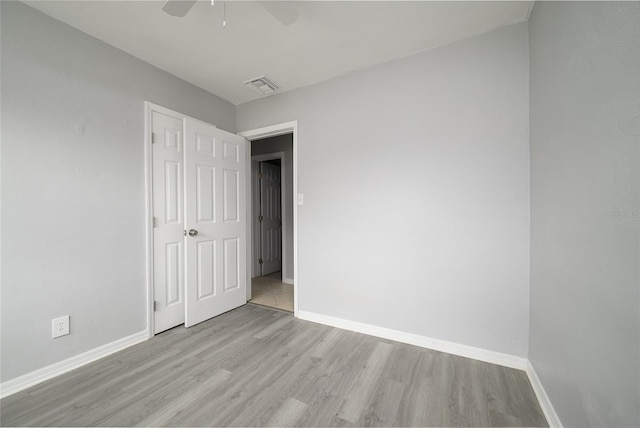 4824 Shoshone St, Orlando, FL 32819 - unfurnished bedroom featuring light wood-style flooring, baseboards, and a closet