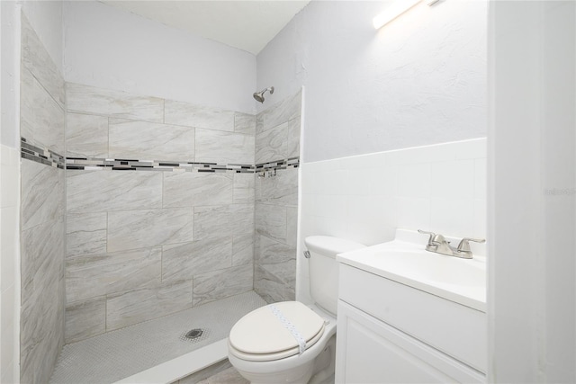 4824 Shoshone St, Orlando, FL 32819 - bathroom with tiled shower, toilet, tile walls, and vanity