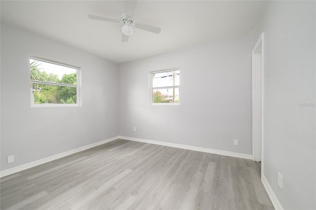 4824 Shoshone St, Orlando, FL 32819 - spare room featuring light wood-style floors, plenty of natural light, baseboards, and a ceiling fan