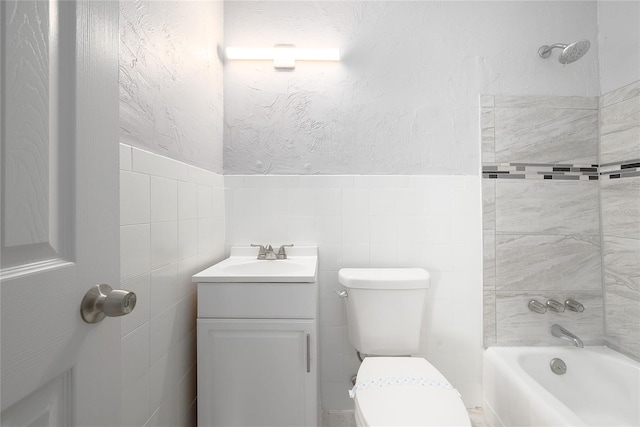 4824 Shoshone St, Orlando, FL 32819 - bathroom with toilet, a textured wall, tile walls, bathtub / shower combination, and vanity